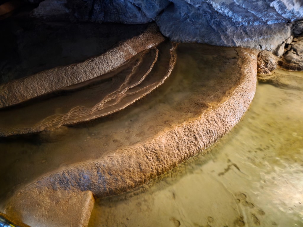 cascading down a series of terraced limestone platforms a little further into the cave